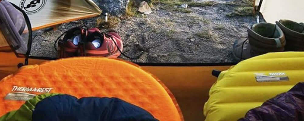 To freeze or not to freeze | R-value: Two camping mats inside a tent with shoes and gear near the entrance.