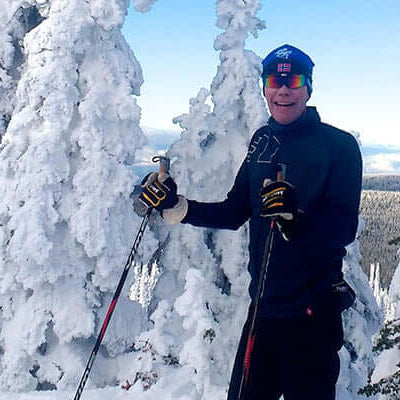 Review: Salomon RC Skin Waxless Skis in a snowy landscape with a skier enjoying the winter scenery.