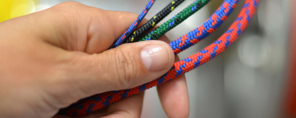 Hand holding colorful ropes, showcasing options for outdoor tasks related to The right rope for the job.