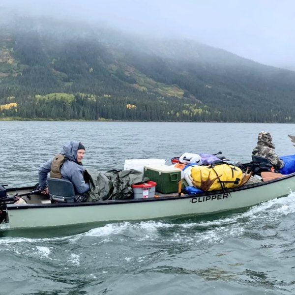 People in loaded canoe with a motor