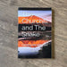 Book titled 'The Churchill and The Snake' by Bob Tosh on a wooden surface