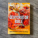 Book titled 'The Dehydrator Bible' on a wooden surface