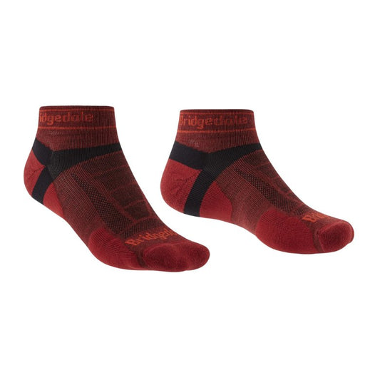 Pair of red socks with black accents on a white background