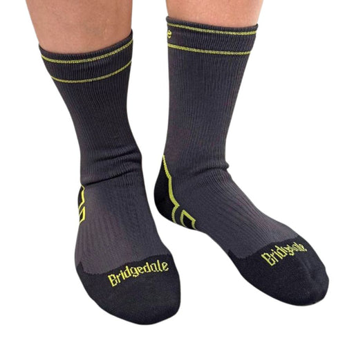 Black socks with yellow accents and 'Bridgedale' branding on a white background