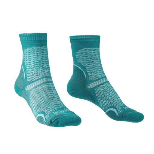 Pair of teal socks with white patterns on a white background