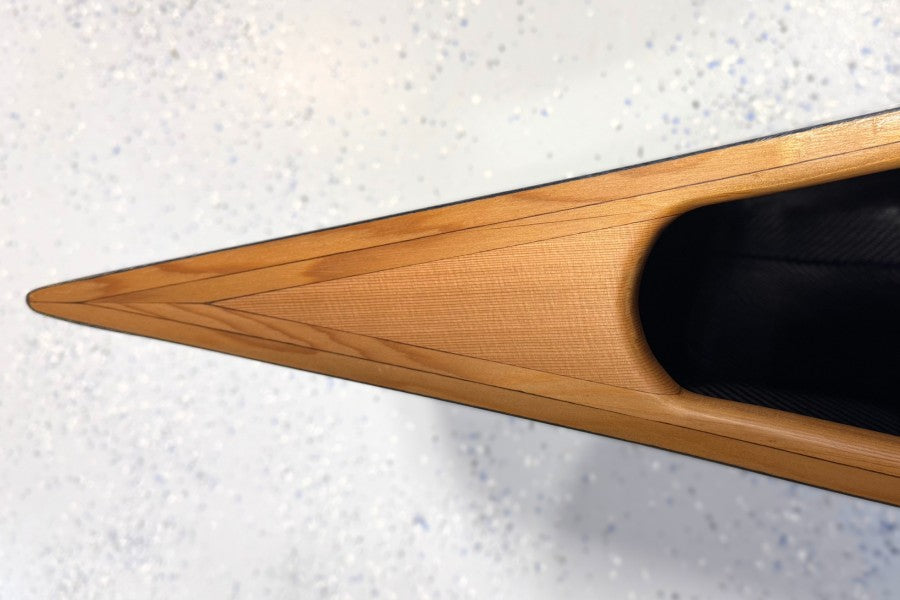 Close-up of a wooden canoe deck on a light gray background