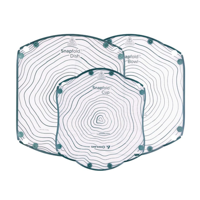 Three snap-on dishware pieces from Coghlans, including a Snapfold Dish, a Snapfold Bowl, and a Snapfold Cup, arranged overlapping on a solid white background. Each piece features a white surface with black concentric topographic-style lines and teal corner accents.