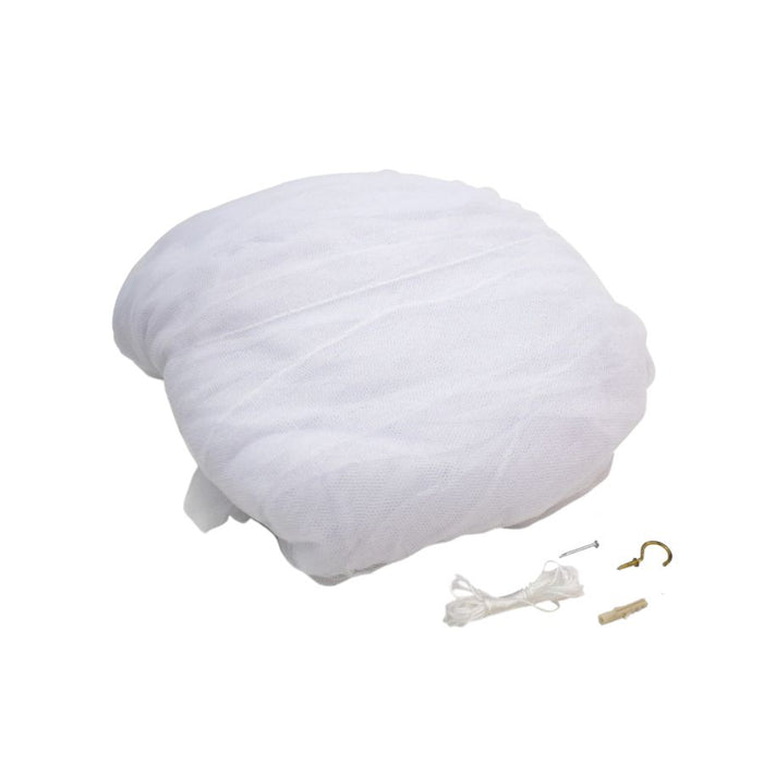 A white mesh or gauze round cushion cover with a gathered, padded appearance, shown on a plain white background with small mounting hardware and cord pieces placed below it.