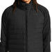 Black puffer jacket worn by a person with dreadlocks on a white background