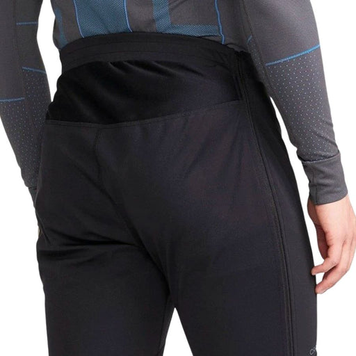 Black pants worn by a person with a white background