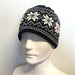 Black and white patterned beanie on a mannequin head against a plain background