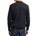 A man wearing a dark charcoal gray knit sweater with red stripe accents on the shoulders, shown from the back against a white background.