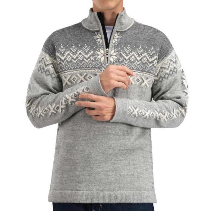 A man wearing a gray half-zip knit sweater with a white Nordic snowflake and geometric pattern across the chest and sleeves, shown against a plain white background.