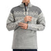 A man wearing a gray half-zip knit sweater with a white Nordic snowflake and geometric pattern across the chest and sleeves, shown against a plain white background.