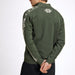A man wearing an olive green knit sweater with white Nordic-style snowflake and geometric patterns on the shoulders and sleeves, shown from a rear three-quarter angle against a plain white background.