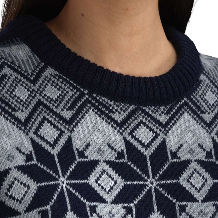 Close up of the neck of a person wearing a navy and grey sweater with nordic patterning.