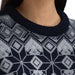 Close up of the neck of a person wearing a navy and grey sweater with nordic patterning.