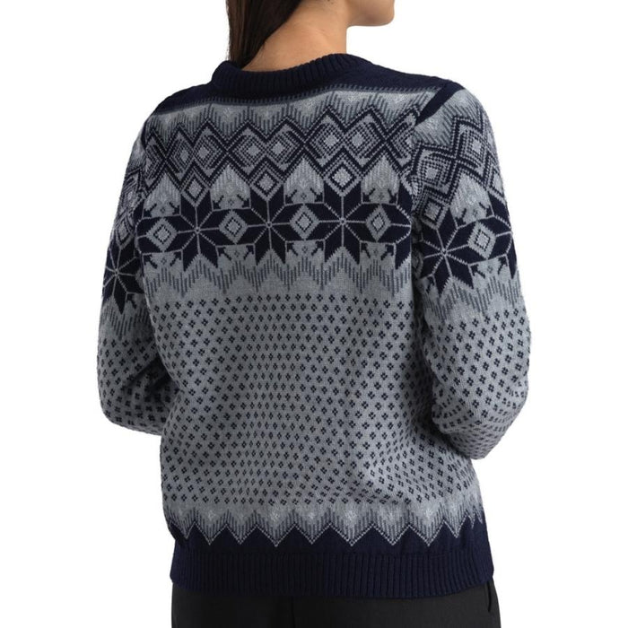 A person shown from the back wearing a navy and gray patterned knit sweater with a Fair Isle style design, set against a plain white background.