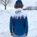 Person wearing a blue and white jacket with 'Ebs' branding in a snowy landscape