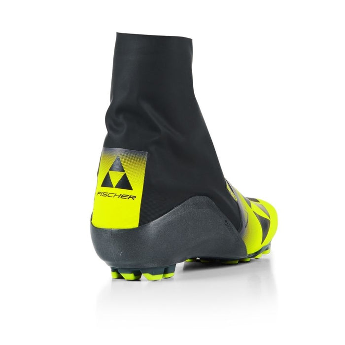 Heel view of a black and yellow ski boot with Fischer branding against a white background.