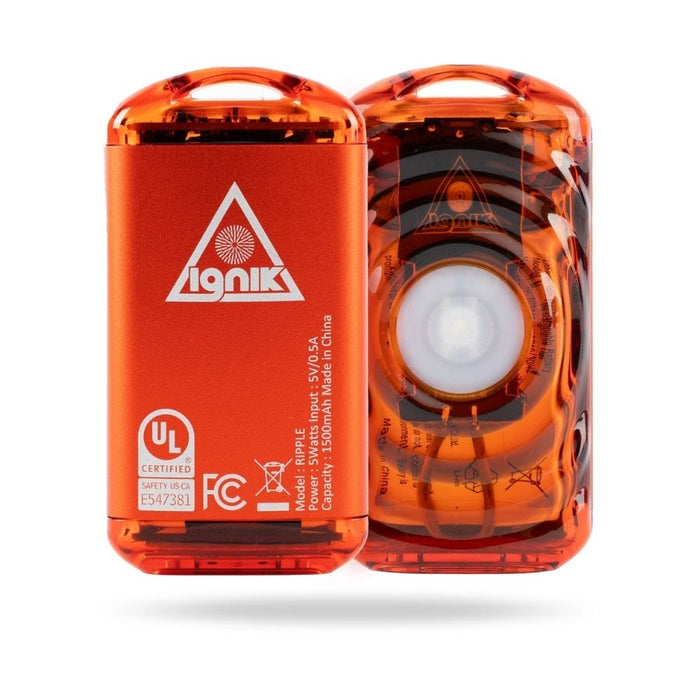 Image showing front and back of an orange metal handwarmer against a white background.