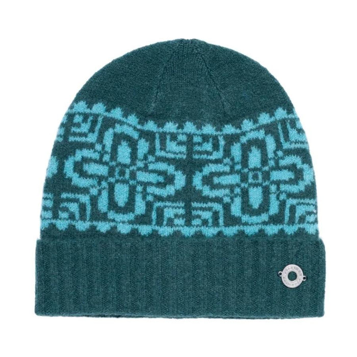 A dark teal knit beanie hat featuring a light blue geometric Fair Isle pattern across the upper half and a ribbed cuff with a small silver metal button closure.