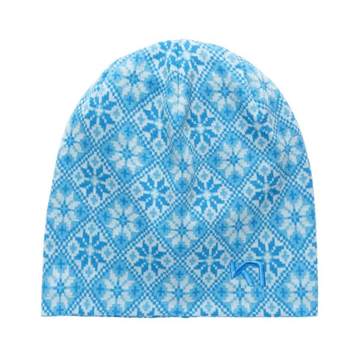A knit beanie hat featuring a light blue and white geometric snowflake pattern, with a small blue stylized logo on the lower right side, set against a plain white background.