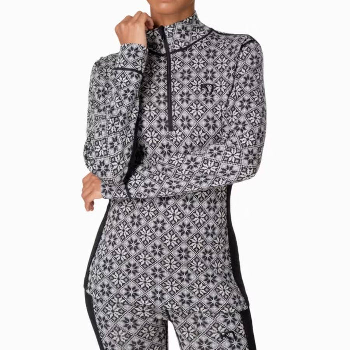A woman wearing a long-sleeve quarter-zip athletic top and matching leggings in a black and light grey Nordic pattern, shown against a plain white background.