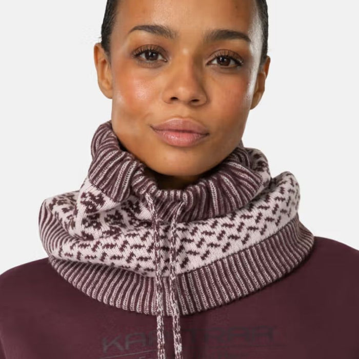 A close-up of a model wearing a ribbed knit cowl neck warmer with a brown and white Nordic pattern, paired with a matching brown ribbed top.