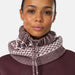 A close-up of a model wearing a ribbed knit cowl neck warmer with a brown and white Nordic pattern, paired with a matching brown ribbed top.