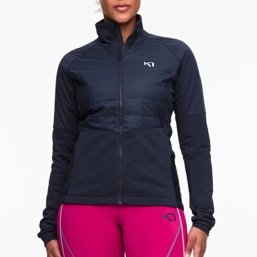 Person wearing a navy jacket and pink leggings with a brand logo on a white background