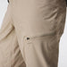 Close-up of beige technical outdoor pants showing a zippered cargo pocket with a small gray NRS logo on the thigh.
