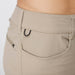 Close-up of a person wearing beige khaki pants, showing the back waistband, belt loops, and a side zip pocket with a black rope D-ring.