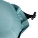 Close-up of a teal fabric with a black toggle on a white background