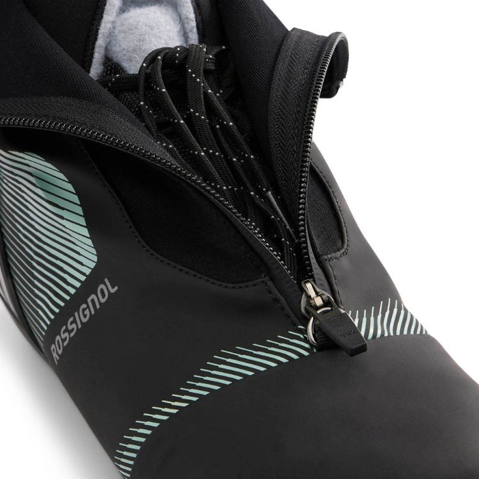 Close-up of a black ski boot with a visible brand logo on a white background