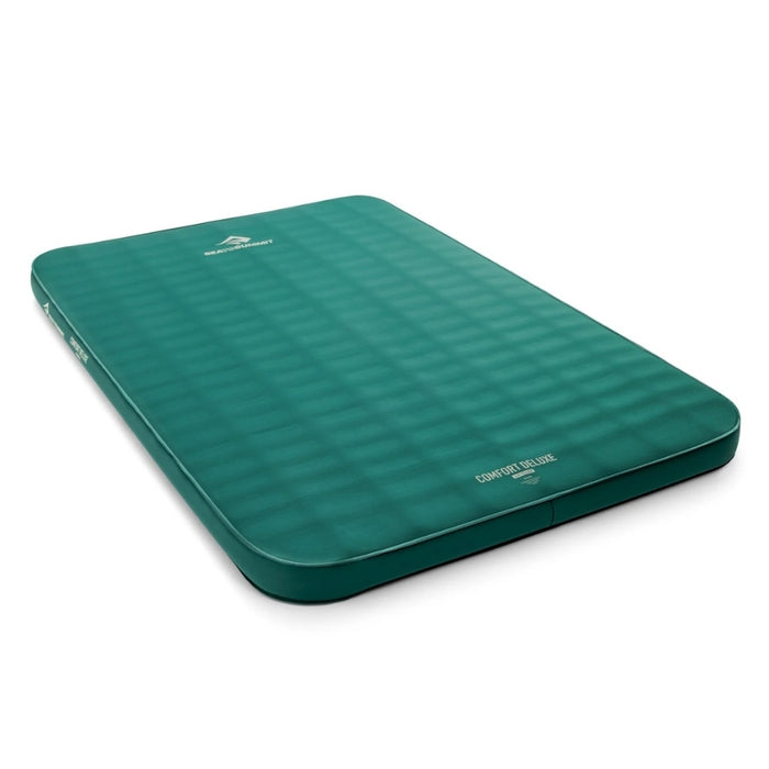 A green inflatable camping sleeping pad with a textured grid pattern, shown at an angle on a white background.
