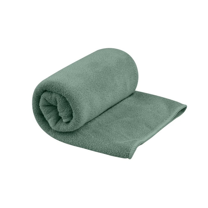 Green rolled up towel on a white background
