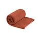 Orange rolled up towel on a white background