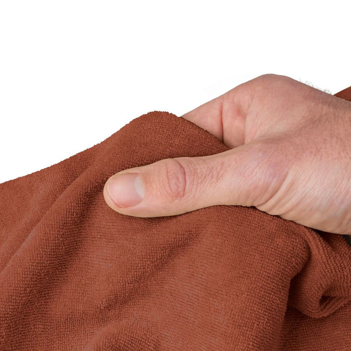 hand holding an orange towel on a white background