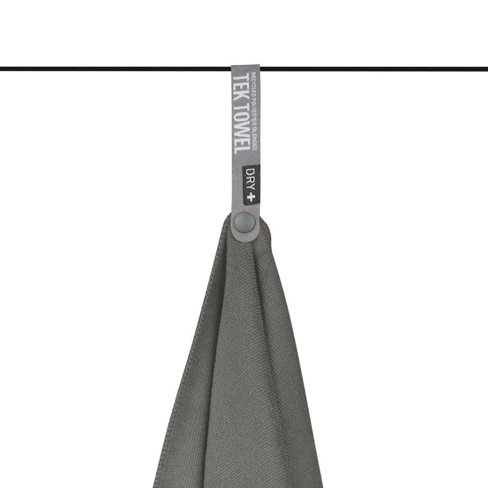 Grey towel hanging on a black line against a white background