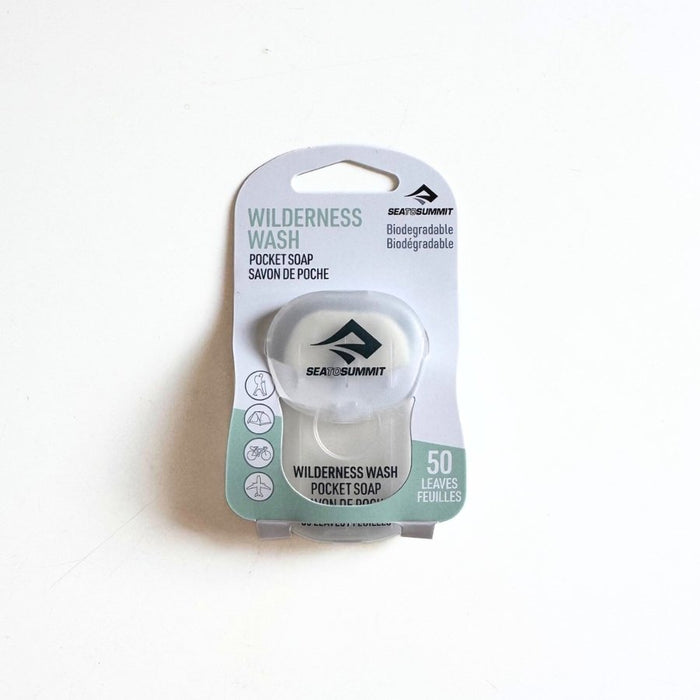 Sea to Summit Wilderness Wash Pocket Soap in its original blister card packaging, featuring a clear, biodegradable soap puck with a black logo, set against a plain white background.
