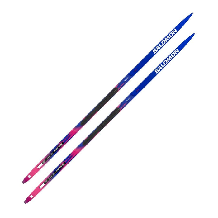 Blue and pink skis with Salomon branding against a white background.