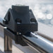 Black roof rack mount on a vehicle with a blurred outdoor background
