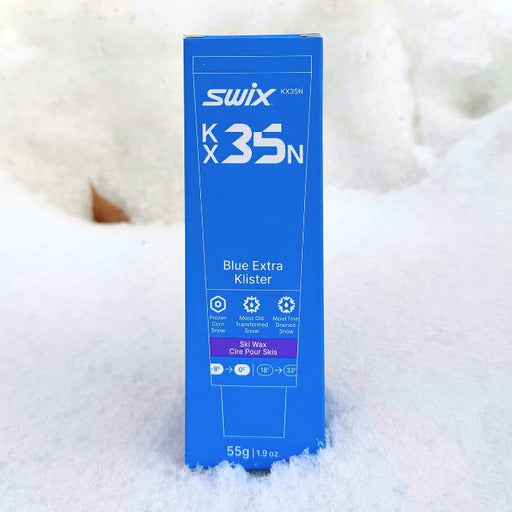 Blue box of Swix K35N ski wax on a snowy background