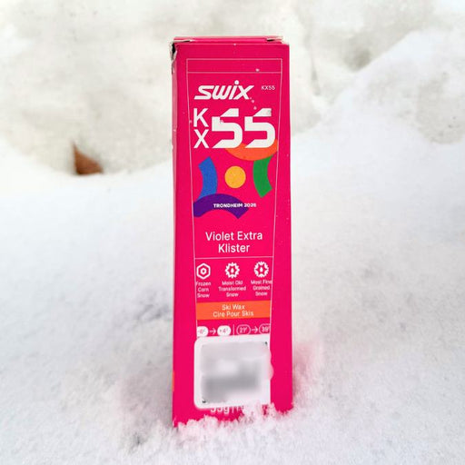 Swix KX55 ski wax box on a snowy background
