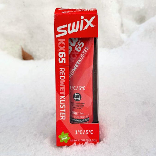 Red Swix KX65 Red Wet klister tube packaging on a snowy background
