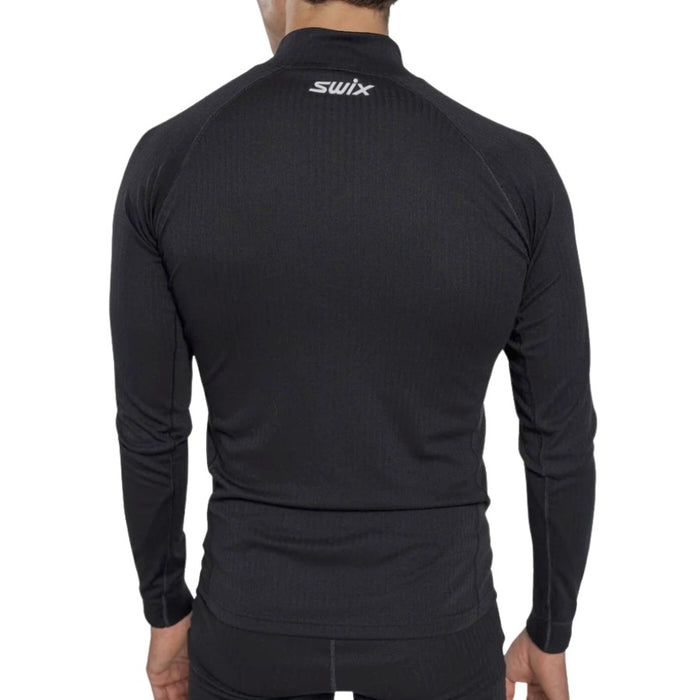 Black long-sleeve athletic shirt with 'Swix' branding on the back, worn by a person.