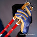 Close up of a hand wearing a blue and tan glove holding red ski poles against a dark background.