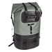 A waterproof roll-top backpack in gray and black, featuring a large black 'T' logo on the front, dual compression straps, and a bottom zippered pocket, shown against a plain white background.