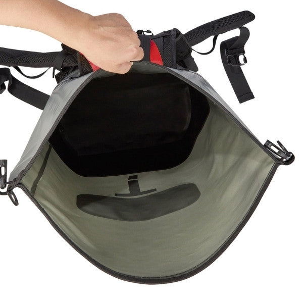 An open gray and black backpack shown from the inside, with a hand holding the top opening and a red accent panel visible at the top center, on a white background.